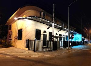 a building on the corner of a street at night at Kenton House in Savannakhet