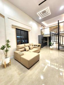 a living room with a couch and a table at Kenton House in Savannakhet