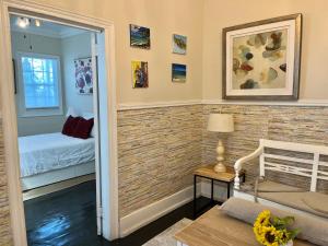 a room with a brick accent wall with a bedroom at Downtown Nassau Oasis Unit 2 in Nassau