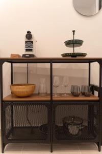 a shelf with wine glasses and a bowl on it at Dorothea Apartment I levestate in Vienna