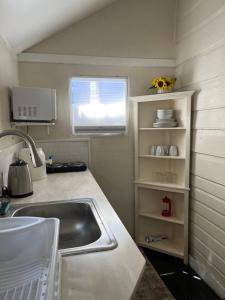 a small kitchen with a sink and a window at Downtown Nassau Oasis Unit 2 in Nassau +18 photos