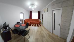 a living room with a couch and a table at Smile apartments in Sighişoara