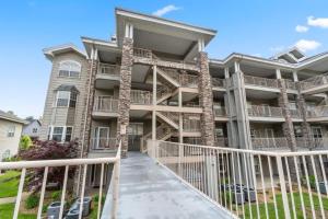 a large apartment building with balconies and a walkway at Branson Condo at Thousand Hills Walkin with Elevator Golf Front and close to 76 in Branson