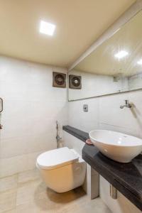 a bathroom with a toilet and a sink at Cottage House at the heart of Bandra. in Mumbai