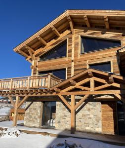 a wooden house with a deck on it at Chalet Mont-Reve in Font-Romeu-Odeillo-Via