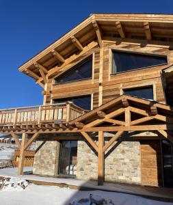 a wooden house with a deck on it at Chalet Mont-Reve in Font Romeu Odeillo Via