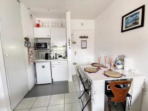 cocina con armarios blancos y encimera en Les Thermes d'Evian - Appartement de vacances, en Évian-les-Bains
