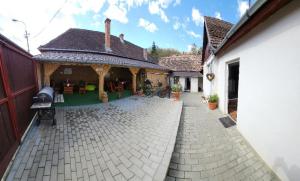 a house with a brick walkway next to a building at Smile apartments in Sighişoara