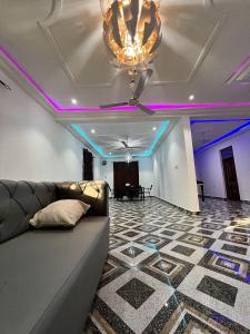a living room with a couch and a stage at Lovely 5-Bed House Getaway Duplex in Accra in Accra