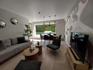 a living room with a couch and a dining room at Les appartements sur Pompidou - 7 appartements neufs société selogerametz com in Metz