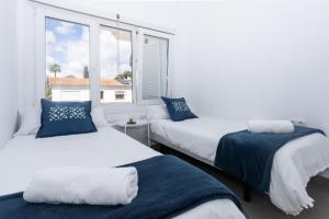 twee bedden in een kamer met een raam bij San Miguel 34 Rooms in Málaga