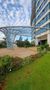 a large building with a glass bridge in front of it at Contemporary apartment at Lemac in Nairobi