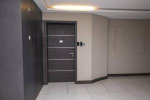 a hallway with a door in a room at Contemporary apartment at Lemac in Nairobi