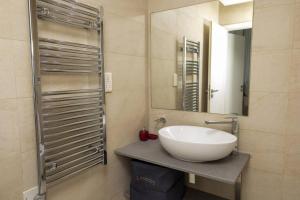 a bathroom with a sink and a mirror at Contemporary apartment at Lemac in Nairobi