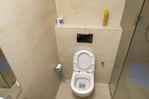 a bathroom with a toilet with a camera on the wall at Contemporary apartment at Lemac in Nairobi