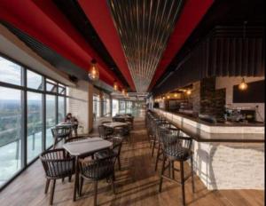 a restaurant with tables and chairs and a bar at Contemporary apartment at Lemac in Nairobi