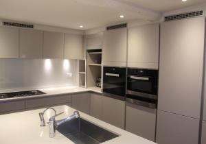 a white kitchen with a sink and a stove at West Pallant Georgian Townhouse in City Centre with Courtyards, BBQ & Log Burners - Dogs Welcome! - Chichester Holiday Properties in Chichester