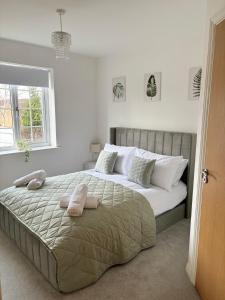 a bedroom with a large bed with two pillows on it at Spacious Retreat with Parking: Ideal for Families & Contractors in York