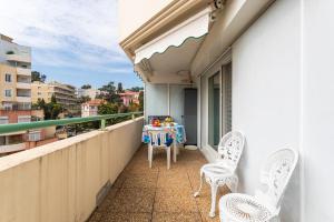 a balcony with two chairs and a table on it at PALAIS DES ARTS AP4399 By Riviera holiday homes in Nice