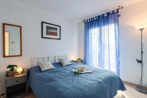 a bedroom with a blue bed and a window at PALAIS DES ARTS AP4399 By Riviera holiday homes in Nice