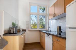 a kitchen with a sink and a window at Seeadler 11 in Buchholz