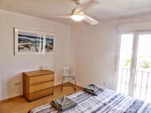 a bedroom with a bed and a dresser and a window at Mar Menor Golf 2 Free Pool, Padel tennis, Gym Yoga etc in Murcia