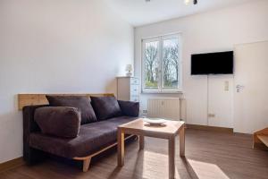 a living room with a couch and a table at Seeadler 11 in Buchholz