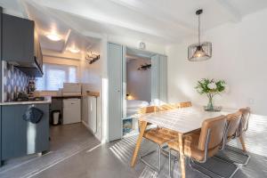 a kitchen and a dining room with a table and chairs at Duinland 110 - Sint Maartenszee in Sint Maartensvlotbrug