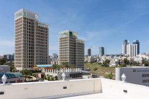 a view of a city skyline with tall buildings at Prestige hotel apartment in Amman