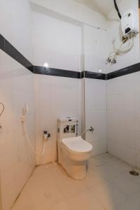 a bathroom with a toilet in a room at HOTEL SANTHOSH DHABA SUITES-NEAR AIRPORT Zone in Shamshabad