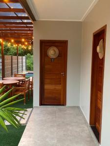 a wooden door in a room with a table at POUSADA ALTER PARA TODOS in Alter do Chao