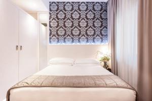 Cama ou camas em um quarto em Hotel Villa Rosa Riviera