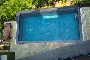 a large blue swimming pool in a building at Amandara Hills Kandy in Kandy