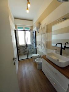 La salle de bains est pourvue d'un lavabo, de toilettes et d'un miroir. dans l'établissement Terzopiano, à Pise
