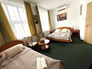 布达佩斯Broadway City Guesthouse的酒店客房,配有两张床和两把椅子