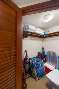 a room with a closet with luggage and a bed at Ko Olina Beach Villas B506 in Kapolei +32 photos