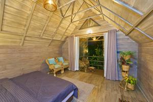 a bedroom with a bed and a balcony at PANCHAVADI FARM STAY in Thekkady