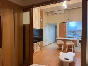 a room with a kitchen and a living room at Party Room, 1min to Suwon Rodeo Street in Suwon