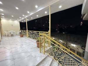 a balcony with a view of the city at night at City Hostel Dushanbe in Dushanbe