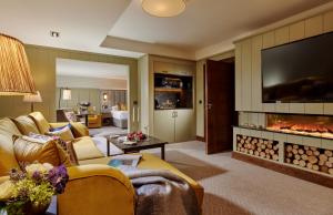 a living room with a couch and a fireplace at Westport Plaza Hotel, Spa & Leisure in Westport