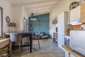 uma cozinha e sala de jantar com mesa e cadeiras em Azura Prugna - Maison avec piscine partagée em Grosseto-Prugna