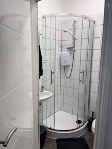 a bathroom with a shower and a sink at Meadow Street Rooms in Avonmouth