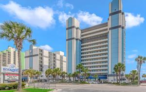 a large building with palm trees in a parking lot at Boardwalk 1139 & 1140 in Myrtle Beach