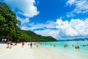 a group of people in the water on a beach at 普吉岛自然-YYC旅游优选酒店 Phuket Nature-YYC Travel Preferred Hotel in Patong Beach