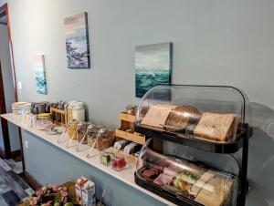 a bakery counter with bread and other food items at Fairy Bridge Lodge in Bundoran