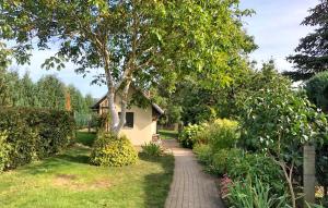 a walkway leading to a house in a garden at Lovely Home In Boitzenburger Land With Kitchen in Haßleben