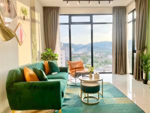 a living room with a green couch and a table at Beacon Executive Suites - Georgetown Luxury 2 Bedrooms Suites in George Town