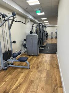 a gym with a row of treadmills and machines at Cedars Southview, Skegness in Skegness