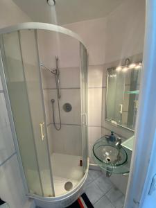 a bathroom with a shower and a sink at Studio Proche Paris in Chaville