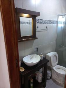 a bathroom with a sink and a toilet at Casa amplia y bien ubicada in Artigas